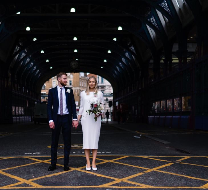 Bride in Pleats Please Issey Miyak Dress | Groom in Beggars Run Suit | Chic London Wedding at St Bartholomew the Great Church & St John Bar & Restaurant | Helen Abraham Photography