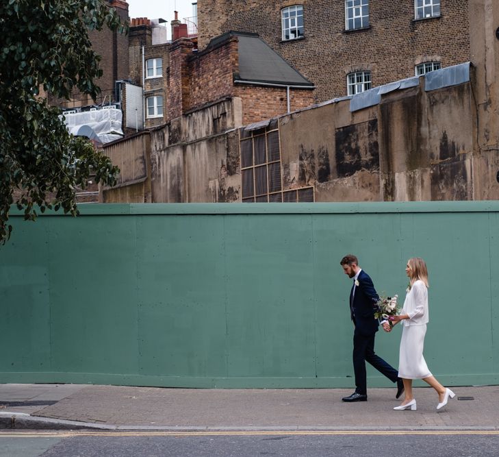 Bride in Pleats Please Issey Miyak Dress | Groom in Beggars Run Suit | Chic London Wedding at St Bartholomew the Great Church & St John Bar & Restaurant | Helen Abraham Photography