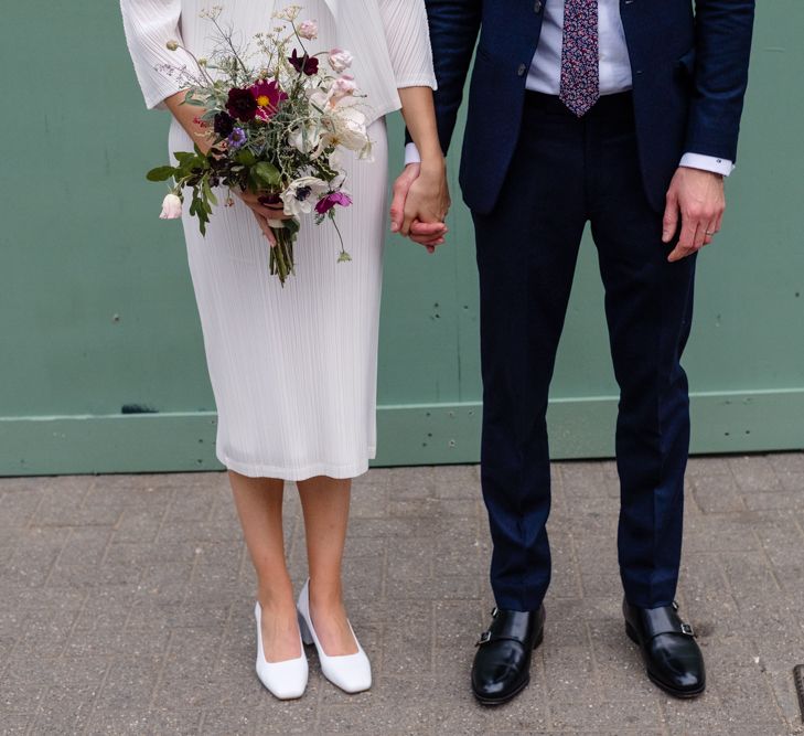 Bride in Pleats Please Issey Miyak Dress | Groom in Beggars Run Suit | Chic London Wedding at St Bartholomew the Great Church & St John Bar & Restaurant | Helen Abraham Photography