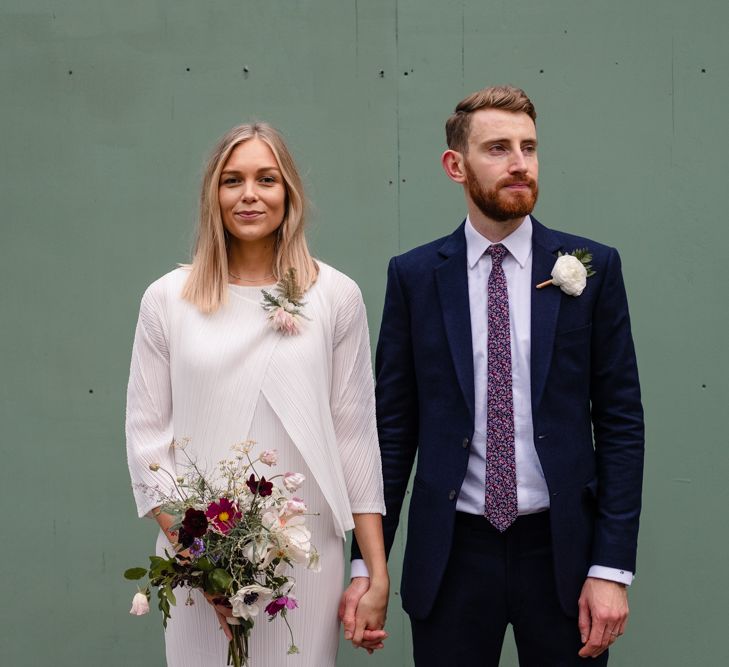 Bride in Pleats Please Issey Miyak Dress | Groom in Beggars Run Suit | Chic London Wedding at St Bartholomew the Great Church & St John Bar & Restaurant | Helen Abraham Photography