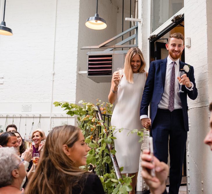 Bride in Pleats Please Issey Miyak Dress | Groom in Beggars Run Suit | Chic London Wedding at St Bartholomew the Great Church & St John Bar & Restaurant | Helen Abraham Photography