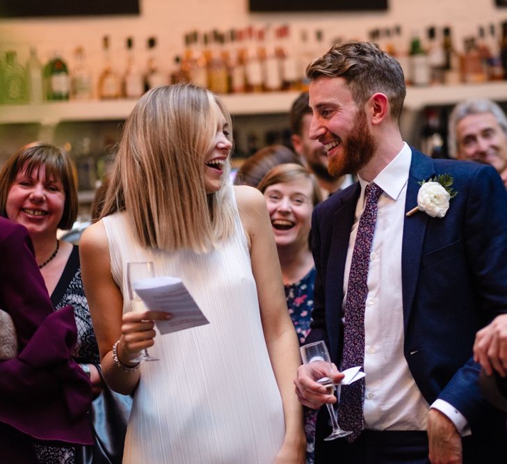 Bride in Pleats Please Issey Miyak Dress | Groom in Beggars Run Suit | Chic London Wedding at St Bartholomew the Great Church & St John Bar & Restaurant | Helen Abraham Photography