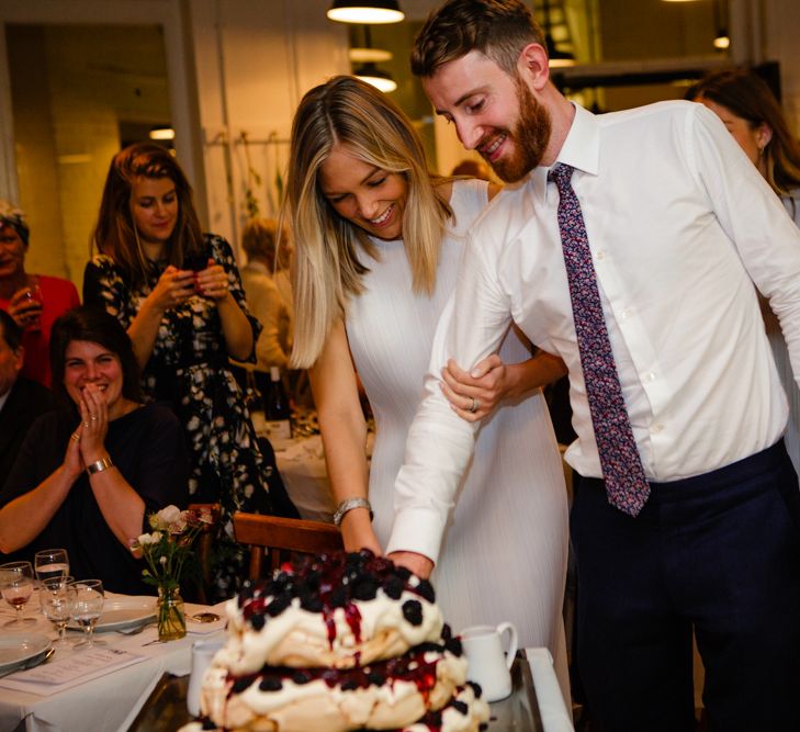 Cutting the Cake | Bride in Pleats Please Issey Miyak Dress | Groom in Beggars Run Suit | Chic London Wedding at St Bartholomew the Great Church & St John Bar & Restaurant | Helen Abraham Photography