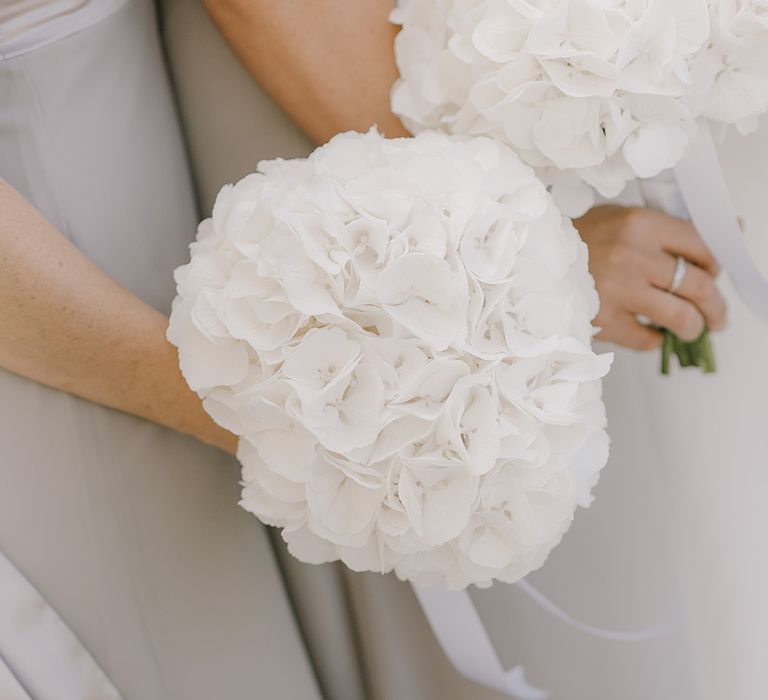 White Hydrangea Bridesmaid Posey | Elegant Black Tie Wedding with White Flowers at The Cleveland Tontine, North Yorkshire | Georgina Harrison Photography