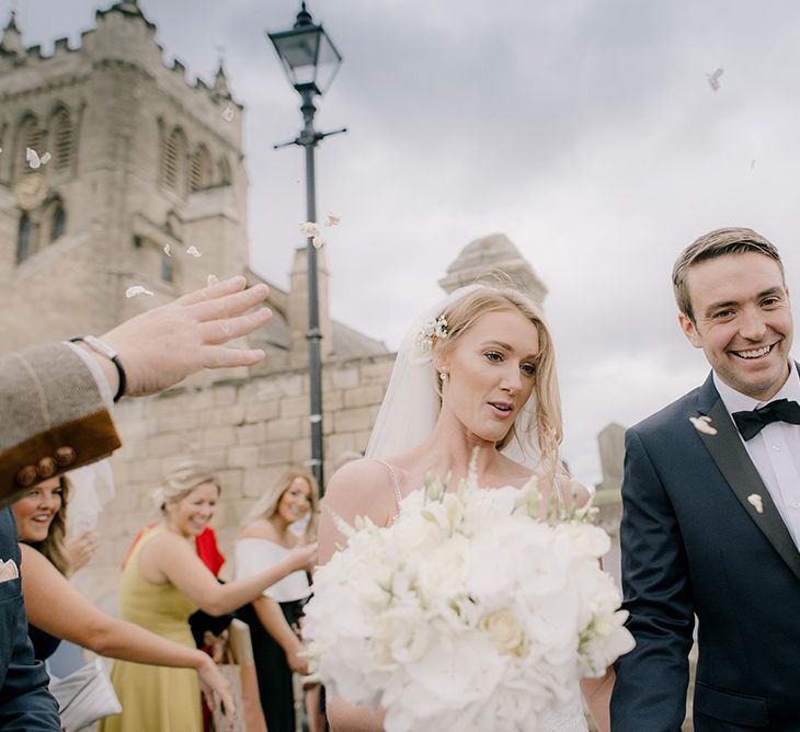 Confetti Exit | Bride in Enzoani Juri Bridal Gown | Groom in Black Tie | Elegant Black Tie Wedding with White Flowers at The Cleveland Tontine, North Yorkshire | Georgina Harrison Photography