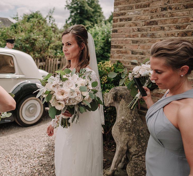 Bride in Lace Pronovias Wedding Dress | Bridesmaids in Grey Dessy Dresses | White and Silver English Country Garden At Home Marquee Wedding | Jason Mark Harris Photography