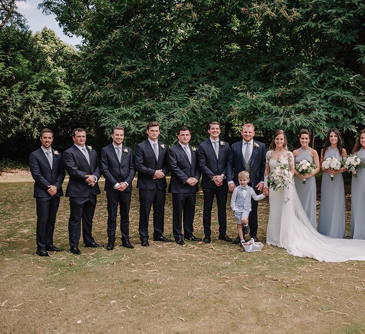 Wedding Party | Bride in Lace Pronovias Bridal Gown | Bridesmaids in Grey Dessy Dresses | Groom in Thom Sweeney Suit | White and Silver English Country Garden At Home Marquee Wedding | Jason Mark Harris Photography