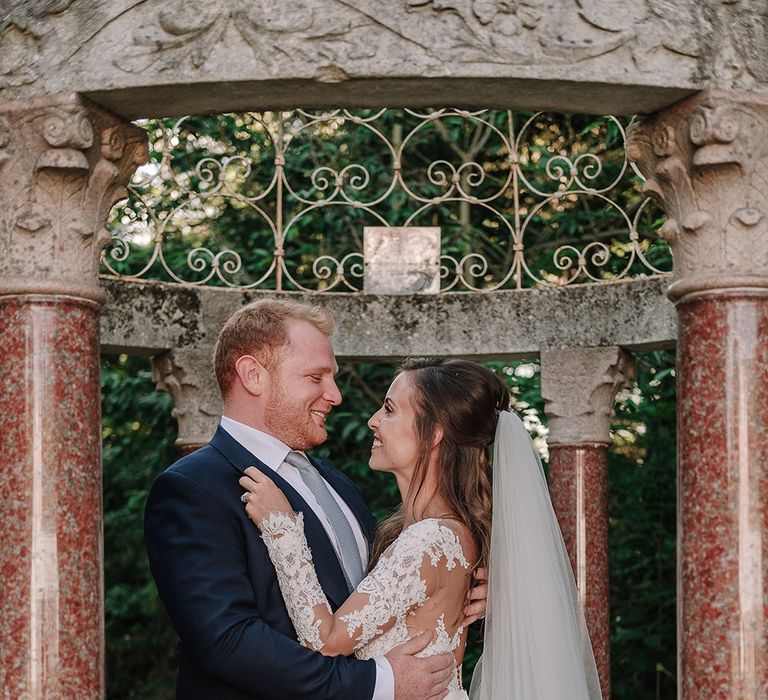 Bride in Lace Pronovias Bridal Gown | Groom in Thom Sweeney Suit | White and Silver English Country Garden At Home Marquee Wedding | Jason Mark Harris Photography