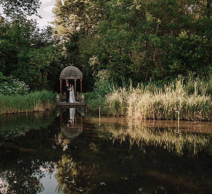 Bride in Lace Pronovias Bridal Gown | Groom in Thom Sweeney Suit | White and Silver English Country Garden At Home Marquee Wedding | Jason Mark Harris Photography