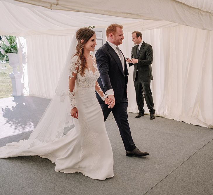 Bride in Lace Pronovias Bridal Gown | Groom in Thom Sweeney Suit | White and Silver English Country Garden At Home Marquee Wedding | Jason Mark Harris Photography