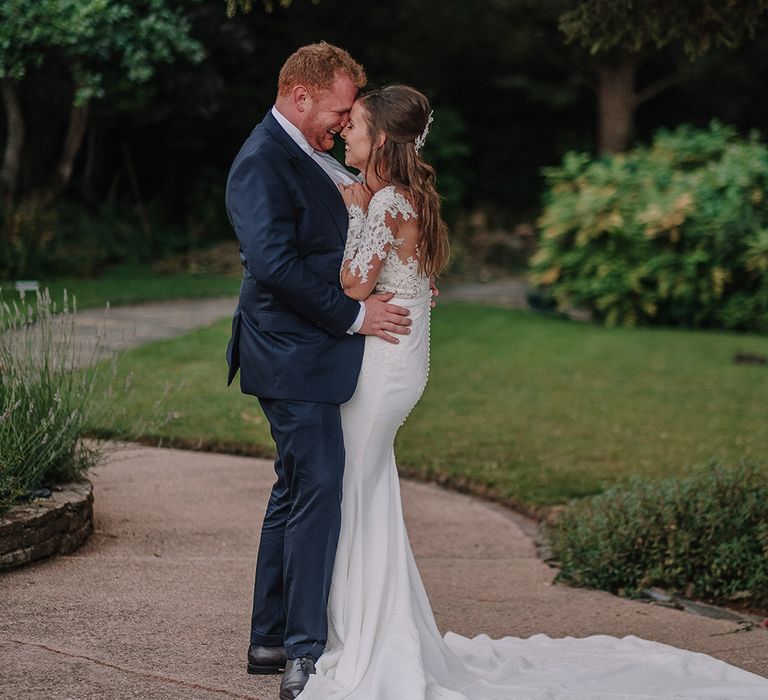 Bride in Lace Pronovias Bridal Gown | Groom in Thom Sweeney Suit | White and Silver English Country Garden At Home Marquee Wedding | Jason Mark Harris Photography