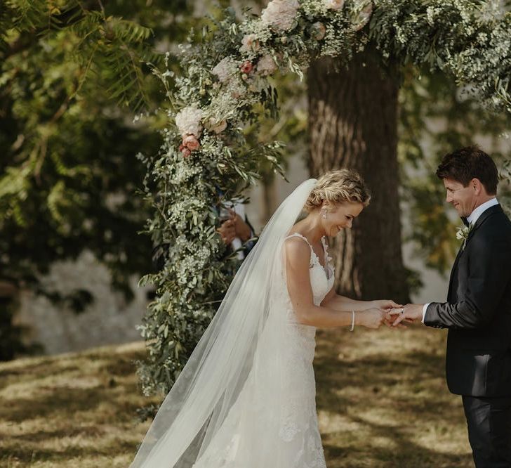 Wedding Ceremony | Floral Arch | Bride in Lace Stella York Dress | Groom in Black Tie | Outdoor Destination Wedding at Château de Saint Martory in France Planned by Senses Events | Danelle Bohane Photography | Matthias Guerin Films