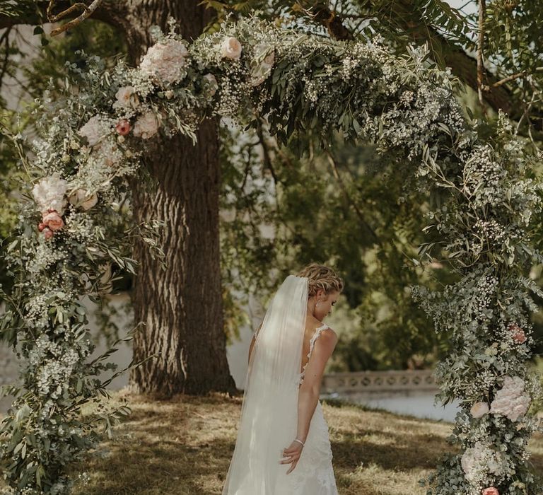 Floral Arch | Bride in Lace Stella York Dress | Outdoor Destination Wedding at Château de Saint Martory in France Planned by Senses Events | Danelle Bohane Photography | Matthias Guerin Films