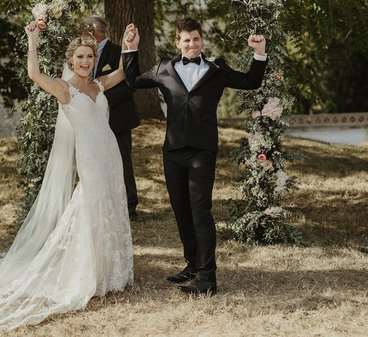 Wedding Ceremony | Floral Arch | Bride in Lace Stella York Dress | Groom in Black Tie | Outdoor Destination Wedding at Château de Saint Martory in France Planned by Senses Events | Danelle Bohane Photography | Matthias Guerin Films