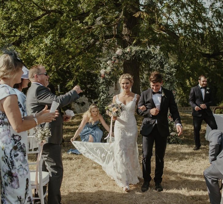 Wedding Ceremony | Floral Arch | Bride in Lace Stella York Dress | Groom in Black Tie | Outdoor Destination Wedding at Château de Saint Martory in France Planned by Senses Events | Danelle Bohane Photography | Matthias Guerin Films