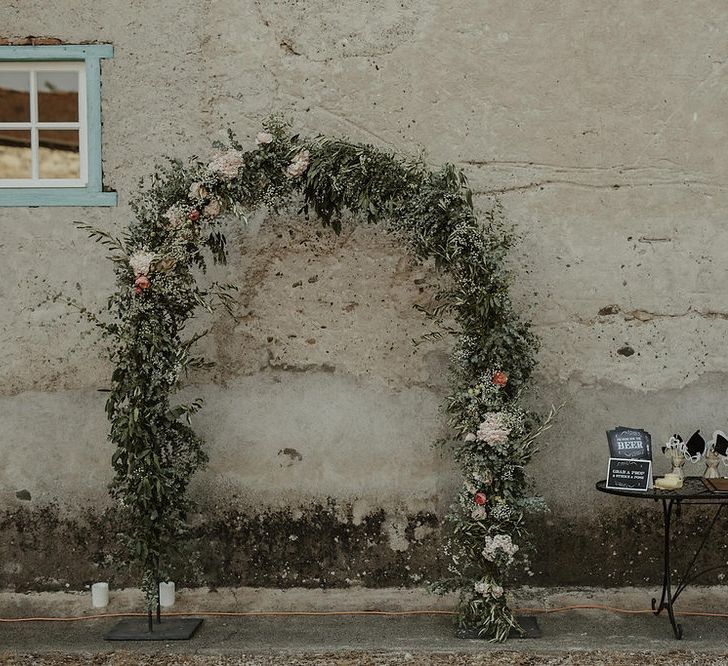 Photo Booth with Floral Arch | Outdoor Destination Wedding at Château de Saint Martory in France Planned by Senses Events | Danelle Bohane Photography | Matthias Guerin Films