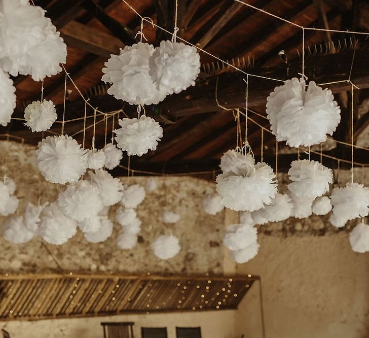 Hanging Pom Poms | Outdoor Destination Wedding at Château de Saint Martory in France Planned by Senses Events | Danelle Bohane Photography | Matthias Guerin Films