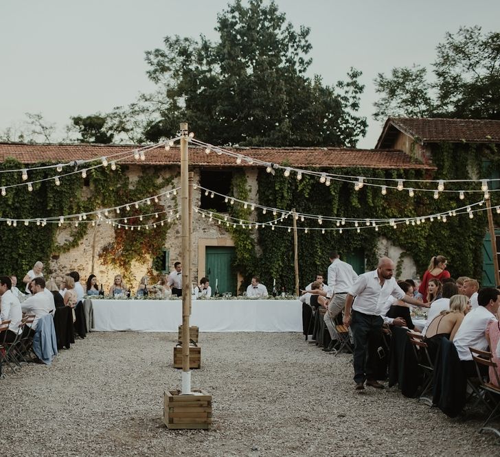 Festoon Lights | Alfresco Reception | Outdoor Destination Wedding at Château de Saint Martory in France Planned by Senses Events | Danelle Bohane Photography | Matthias Guerin Films