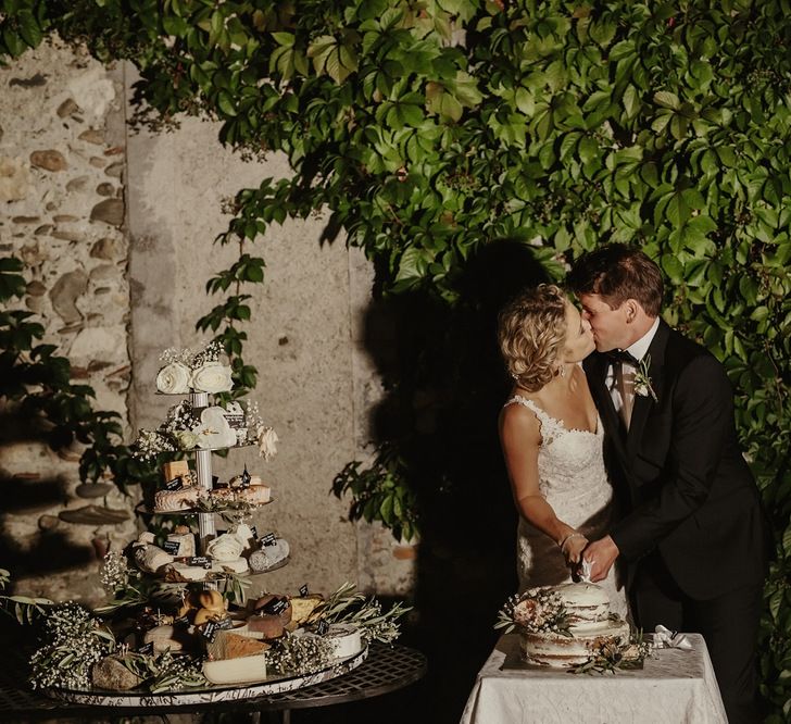 Cutting the Cake | Bride in Lace Stella York Dress | Groom in Black Tie | Outdoor Destination Wedding at Château de Saint Martory in France Planned by Senses Events | Danelle Bohane Photography | Matthias Guerin Films