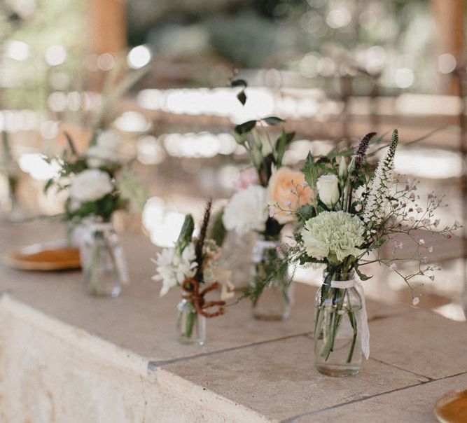 Wedding Table Scape With Cream Linen And Pink Jam Jar Flowers