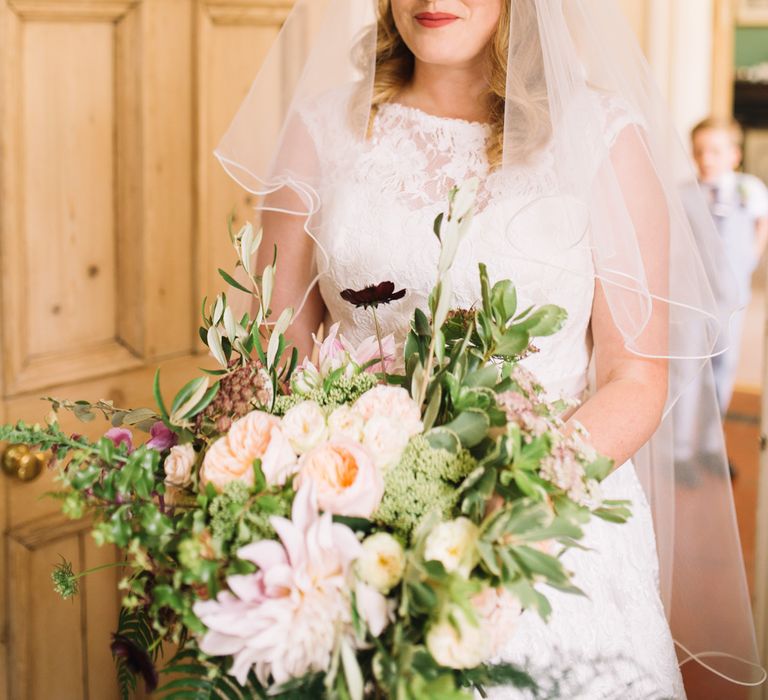 Bride in Lace Justin Alexander Wedding Dress & Peach Bouquet