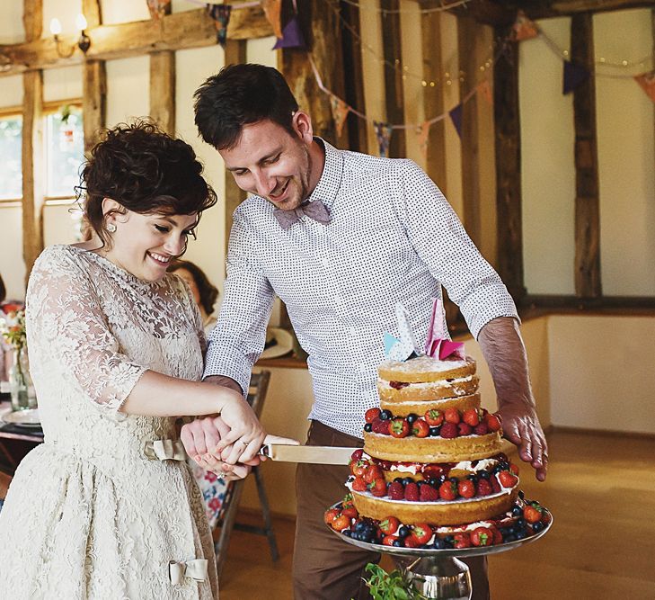 Bride & Groom Cutting The Naked Wedding Cake