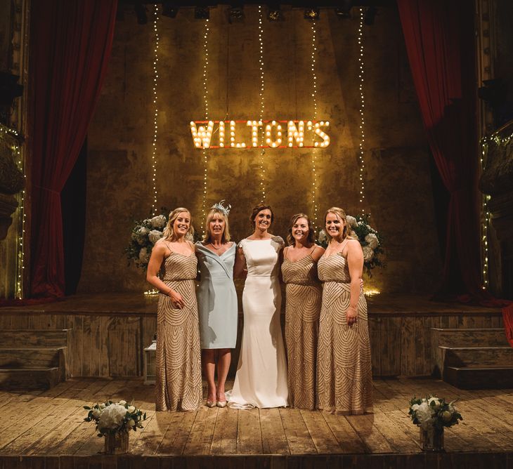 Wiltons Music Hall Wedding With Bride In Paloma Blanca And Bridesmaids In Sequinned Adrianna Papell Gowns Images By Jackson & Co Photography