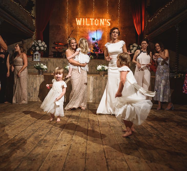 Wiltons Music Hall Wedding With Bride In Paloma Blanca And Bridesmaids In Sequinned Adrianna Papell Gowns Images By Jackson & Co Photography