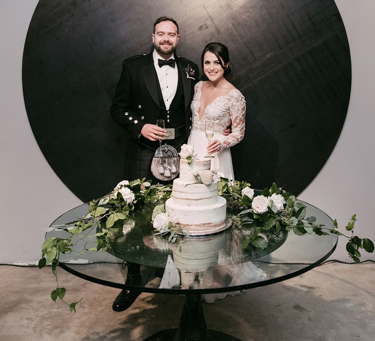 Bride & Groom cutting the Cake | Semi Naked Wedding Cake | Stylish Wedding at the M Building in the Miami Art District | Sara Lobla Photography