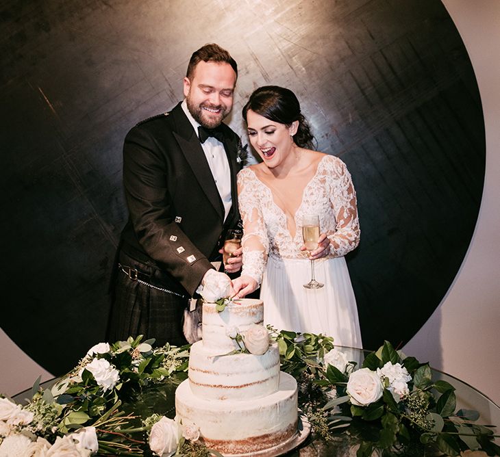 Bride & Groom Cutting the Cake | Semi Naked Wedding Cake | Stylish Wedding at the M Building in the Miami Art District | Sara Lobla Photography