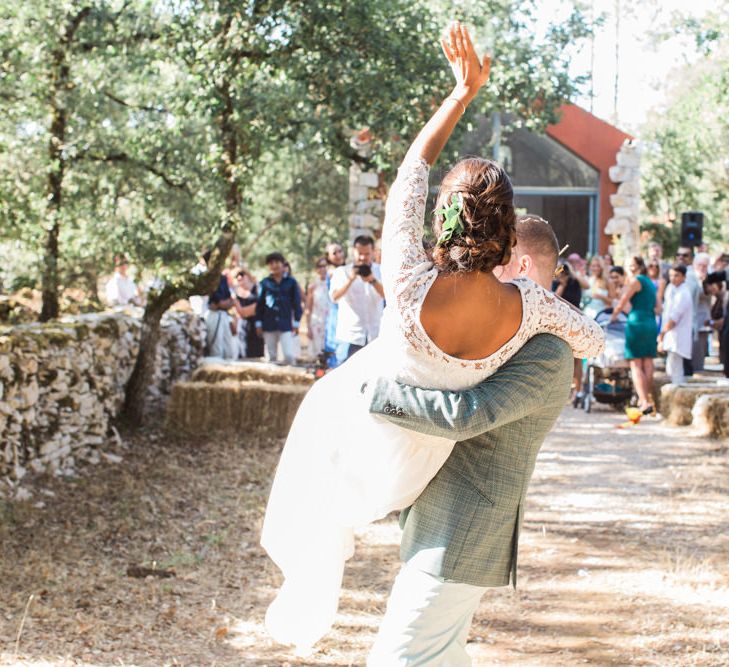 Groom Sweeping his Bride off her Feet