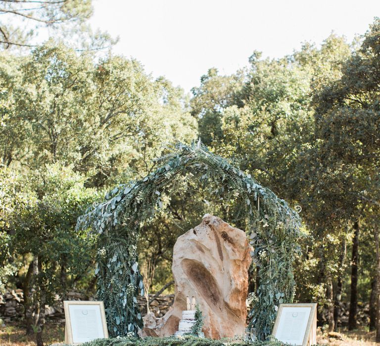 Outdoor Wedding Cake Table with Greenery Arch