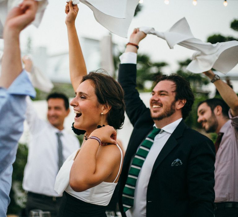 Wedding Guests Waving their Napkins