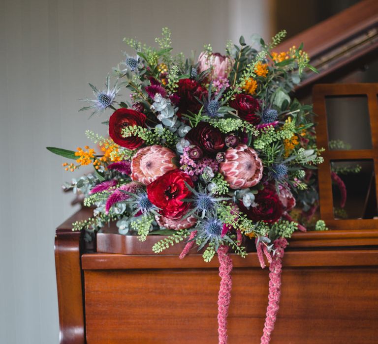 Deep Red, Pink & Greenery Protea Bouquet | Industrial Wedding at The West Mill Venue | Sarah Gray Photography