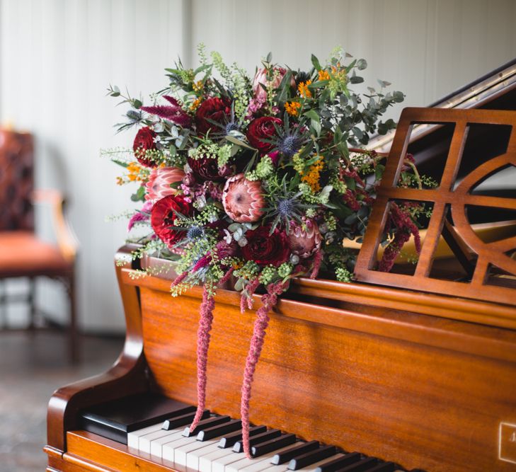 Deep Red, Pink & Greenery Protea Bouquet | Industrial Wedding at The West Mill Venue | Sarah Gray Photography