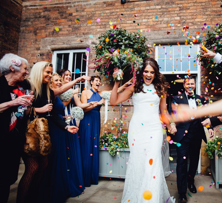 Confetti Exit | Bride in Pronovias Ornani Bridal Gown & Veil | Groom in Charles Tyrwitt Midnight Blue Tuxedo | Industrial Wedding at The West Mill Venue | Sarah Gray Photography