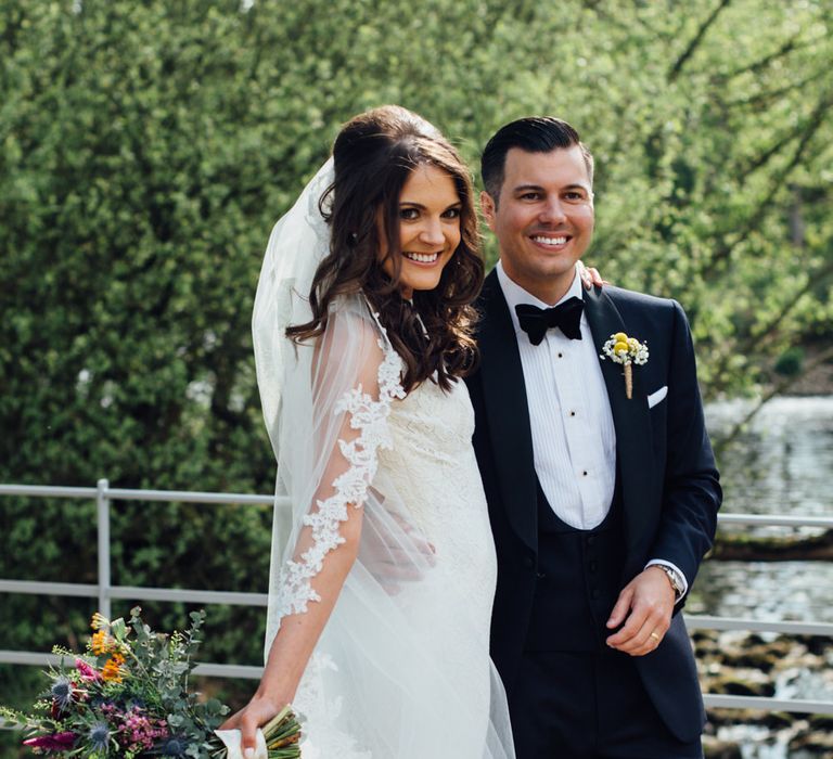 Bride in Pronovias Ornani Bridal Gown & Veil | Groom in Charles Tyrwitt Midnight Blue Tuxedo | Industrial Wedding at The West Mill Venue | Sarah Gray Photography