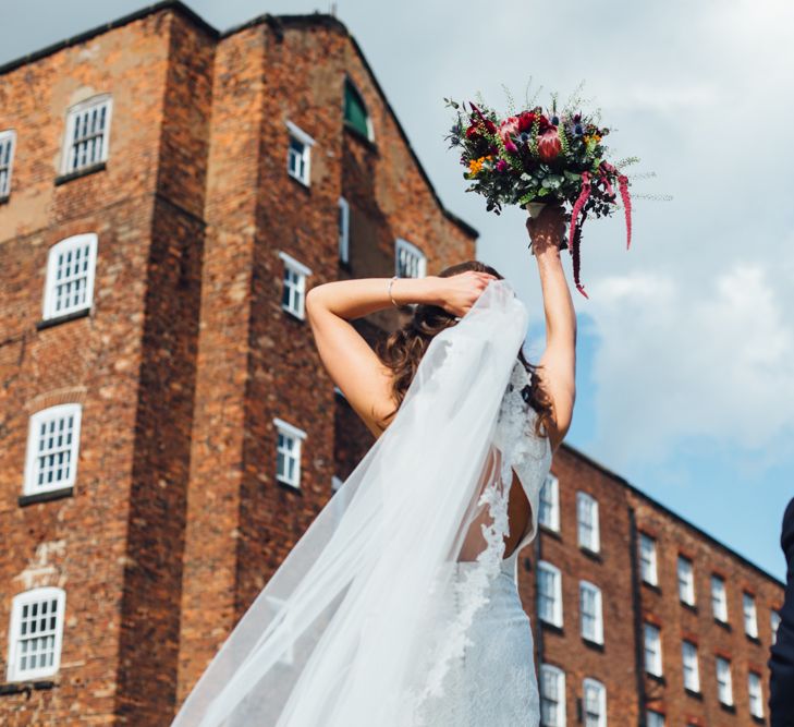 Bride in Pronovias Ornani Bridal Gown & Veil | Groom in Charles Tyrwitt Midnight Blue Tuxedo | Industrial Wedding at The West Mill Venue | Sarah Gray Photography