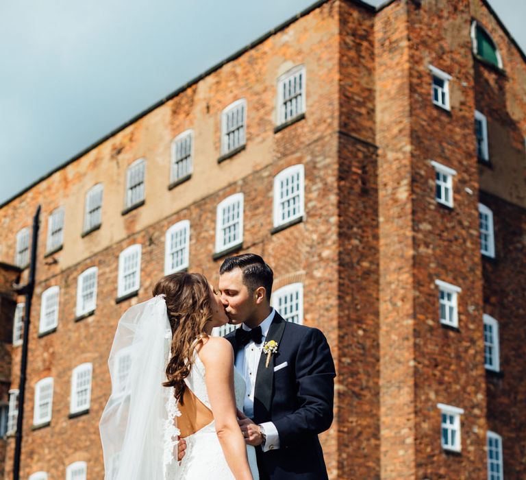 Bride in Pronovias Ornani Bridal Gown & Veil | Groom in Charles Tyrwitt Midnight Blue Tuxedo | Industrial Wedding at The West Mill Venue | Sarah Gray Photography