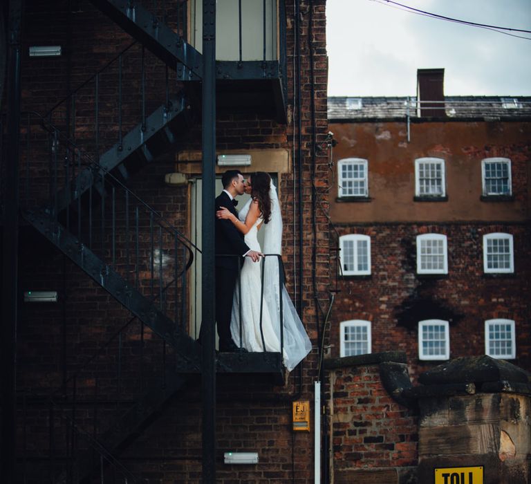 Bride in Pronovias Ornani Bridal Gown & Veil | Groom in Charles Tyrwitt Midnight Blue Tuxedo | Industrial Wedding at The West Mill Venue | Sarah Gray Photography