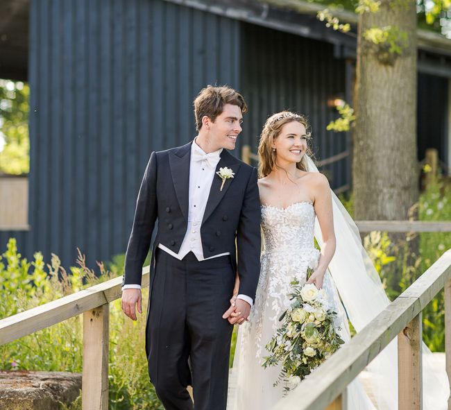 Bride in Mira Zwillinger Bridal Gown | Groom in Black Tie | Rustic Soho Farmhouse Ceremony with PapaKata Sperry Tent Greenery filled Reception | Marianne Taylor Photography | Will Warr Films