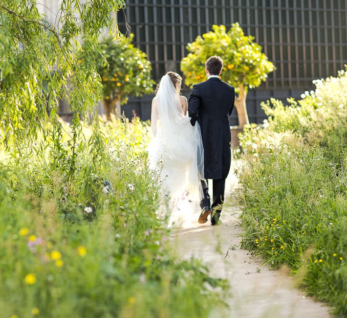 Bride in Mira Zwillinger Bridal Gown | Groom in Black Tie | Rustic Soho Farmhouse Ceremony with PapaKata Sperry Tent Greenery filled Reception | Marianne Taylor Photography | Will Warr Films