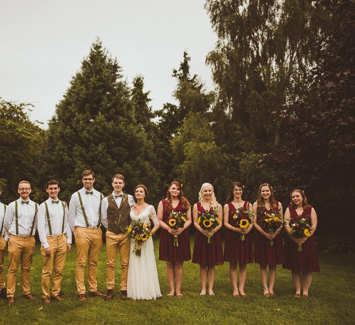 Wedding Party In Yellow Trousers And Red Bridesmaids Dresses