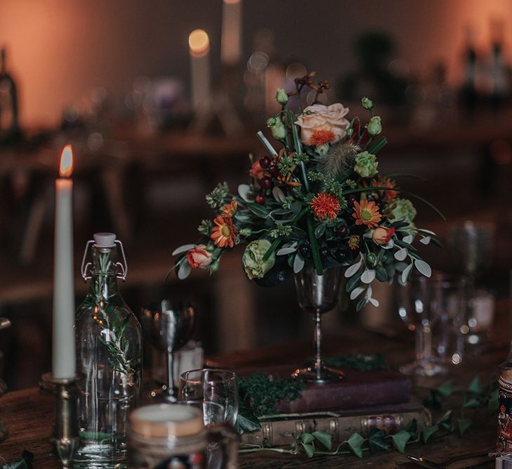 Flower Stems in Goblets on Vintage Book Stack | DIY Lord of the Rings Themed Wedding at Monks Barn in Maidenhead | Jason Mark Harris Photography | Cinematic Films By J