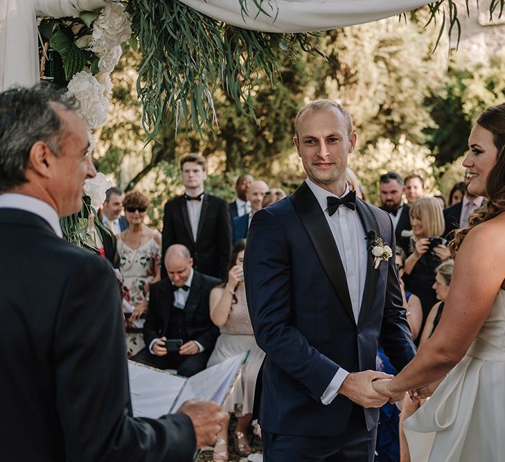 Wedding Ceremony | Bride in Monique Lhuillier Gown | Groom in Tuxedo | Super Luxe Blush, White & Greenery Destination Wedding at Villa Pitiana, Tuscany, Italy | Jason Mark Harris Photography | Angelo La Torre Film