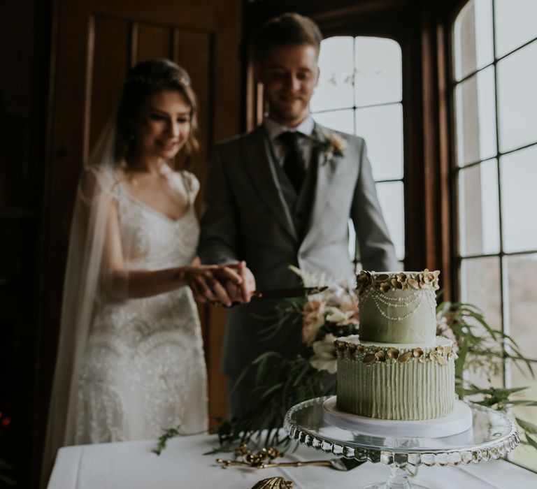 Seafoam Green Wedding Cake With Gold Detail By Peboryon // Magical Winter Elopement Wedding Cornwall With Images By Enchanted Brides Photography & Film By Baxter And Ted With Styling From A Belle & A Brit