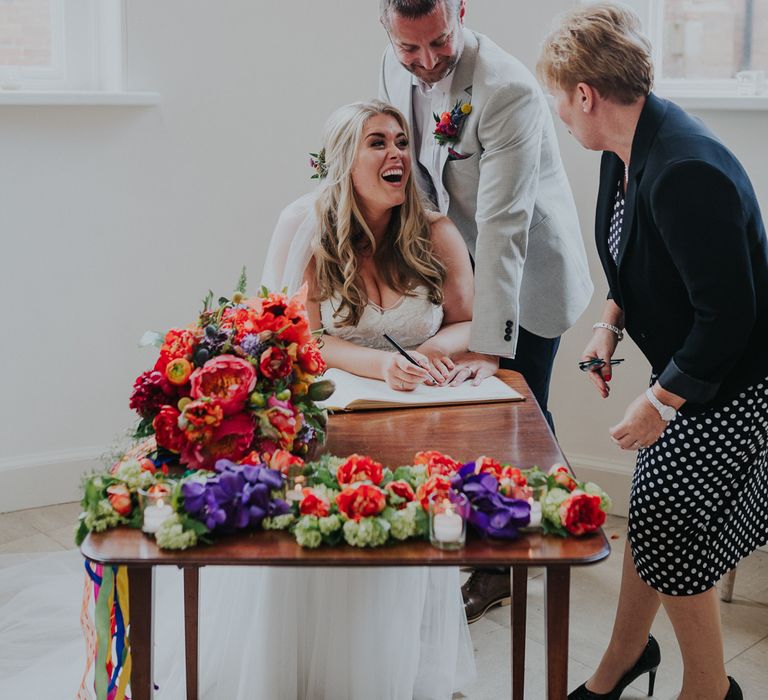 Signing The Register // Colourful Spring Wedding At Iscoyd Park With Coral Charm Peonies And Bride In Pronovias Images From Kate Gray Photography