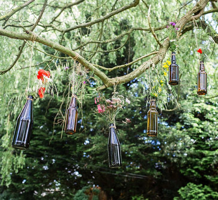 Hanging Brown Bottles with Flower Stems