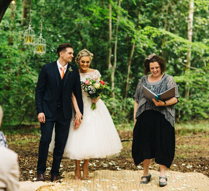 Bride in Short Blue by Enzoani Danbury Gown & Groom in Navy Ted Baker Suit