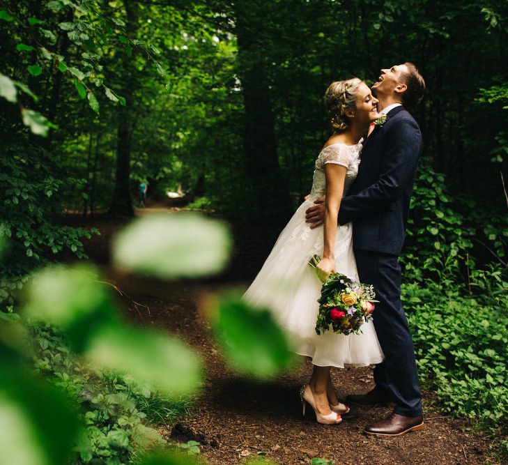 Bride in Short Blue by Enzoani Danbury Gown & Groom in Navy Ted Baker Suit